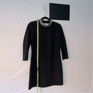 H&M mini black dress 
Open back
With crystals details on neckline